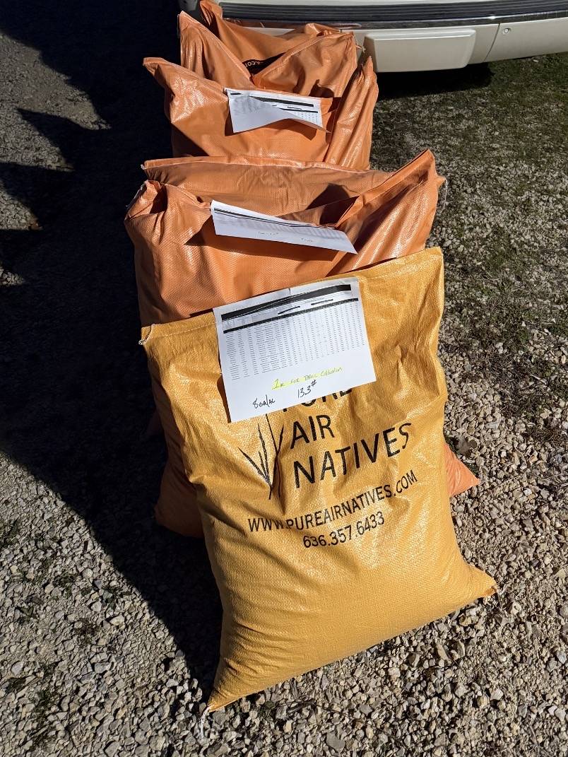 Bags of native seed labeled Pure Air Natives, ready for planting.